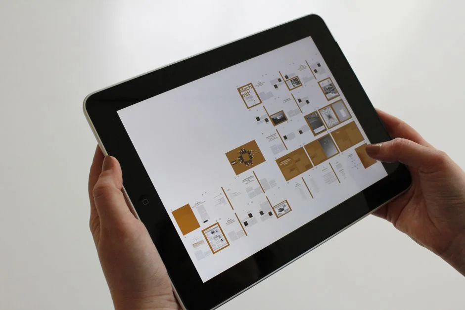 project-03-c A tablet screen featuring images of minimalist decor emphasizing greenery and simple design.